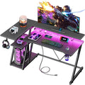 55 Inch L Shaped Gaming Desk with Power Outlet, LED Lights, Storage Shelves, Carbon Fiber Black X715197